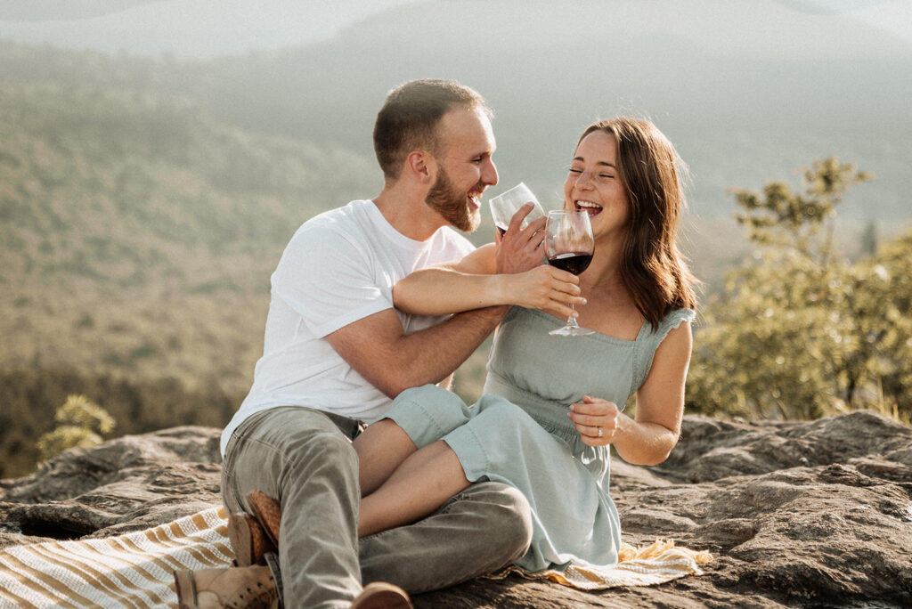 Couple drinking wine on mountaintop