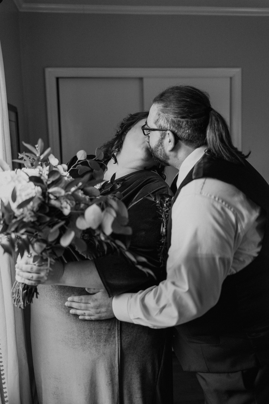 Bride and groom kissing black and white image