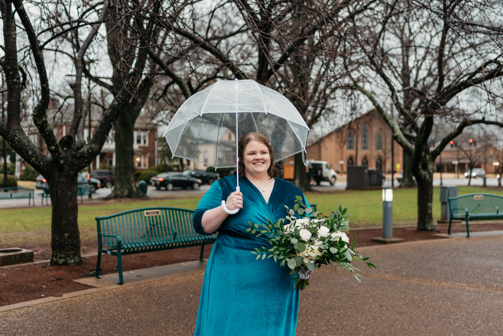 Bride smiling with umbrella