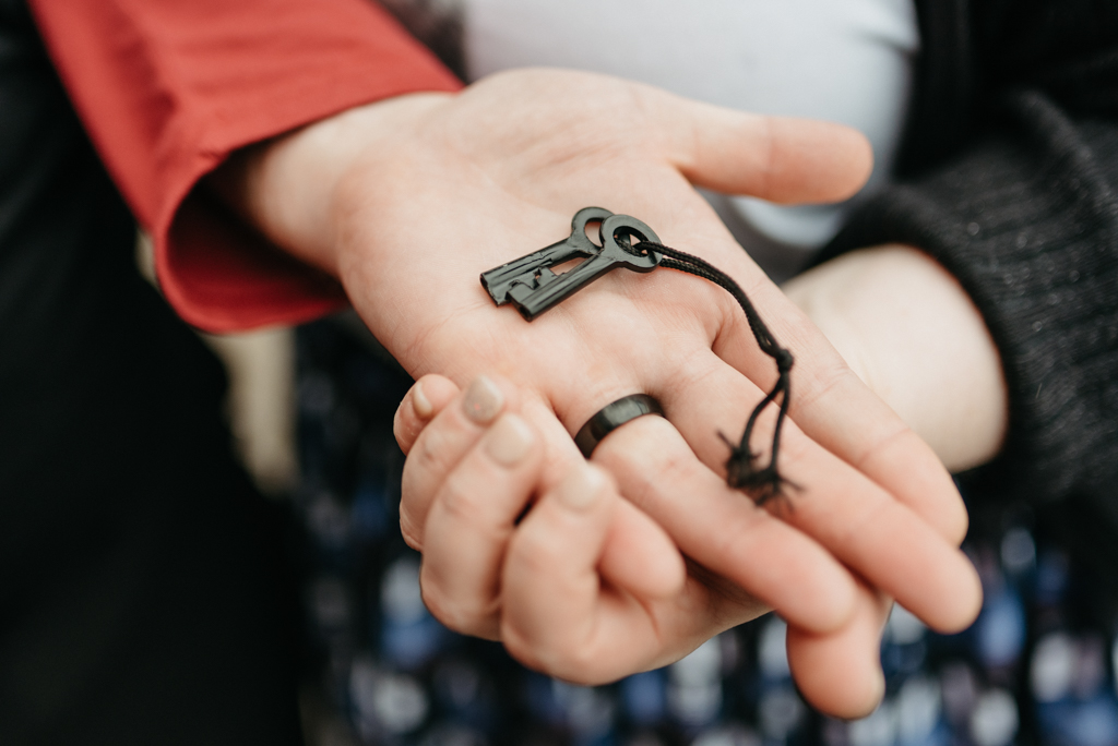 Couple holding keys to lock