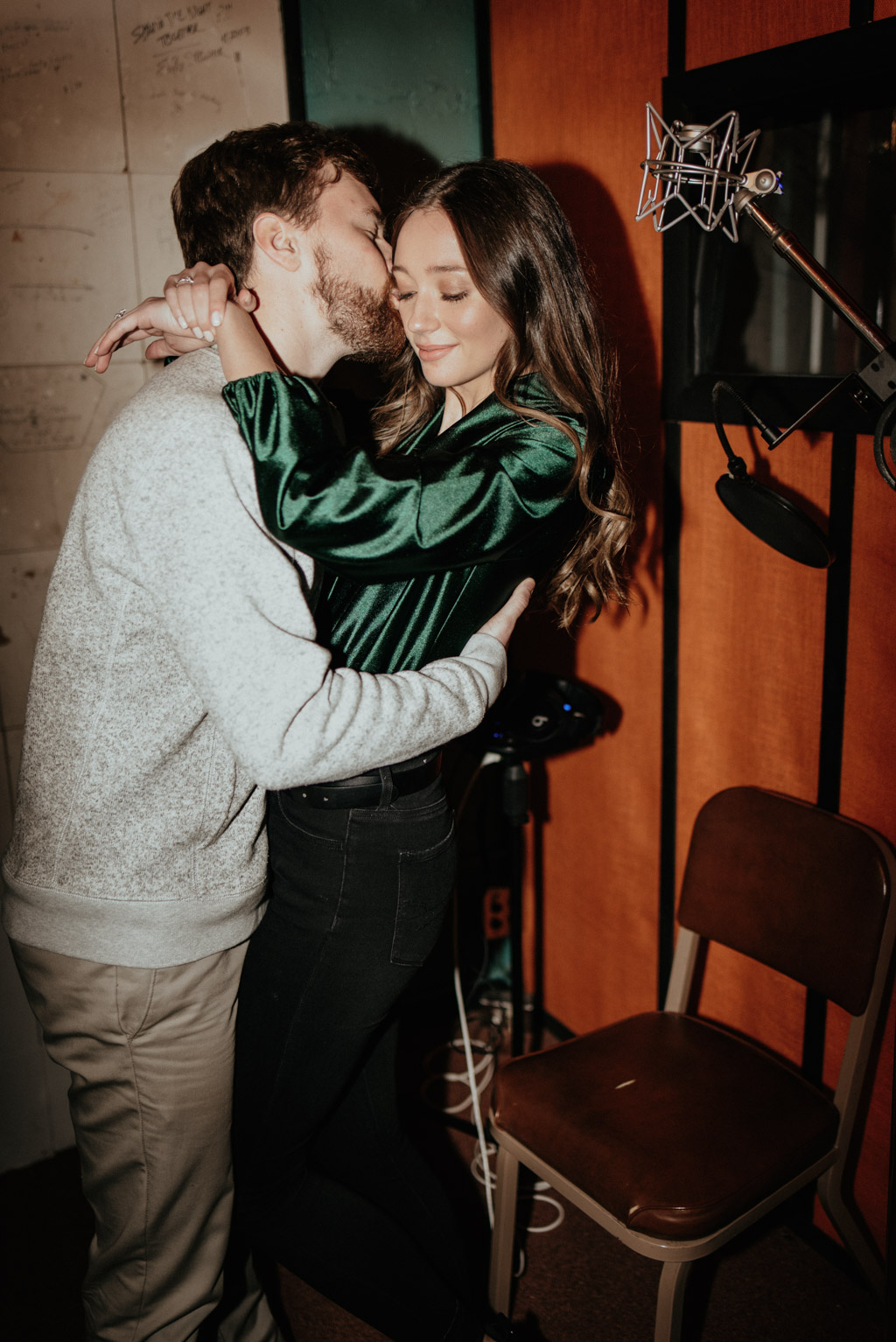 Couple embracing in recording studio