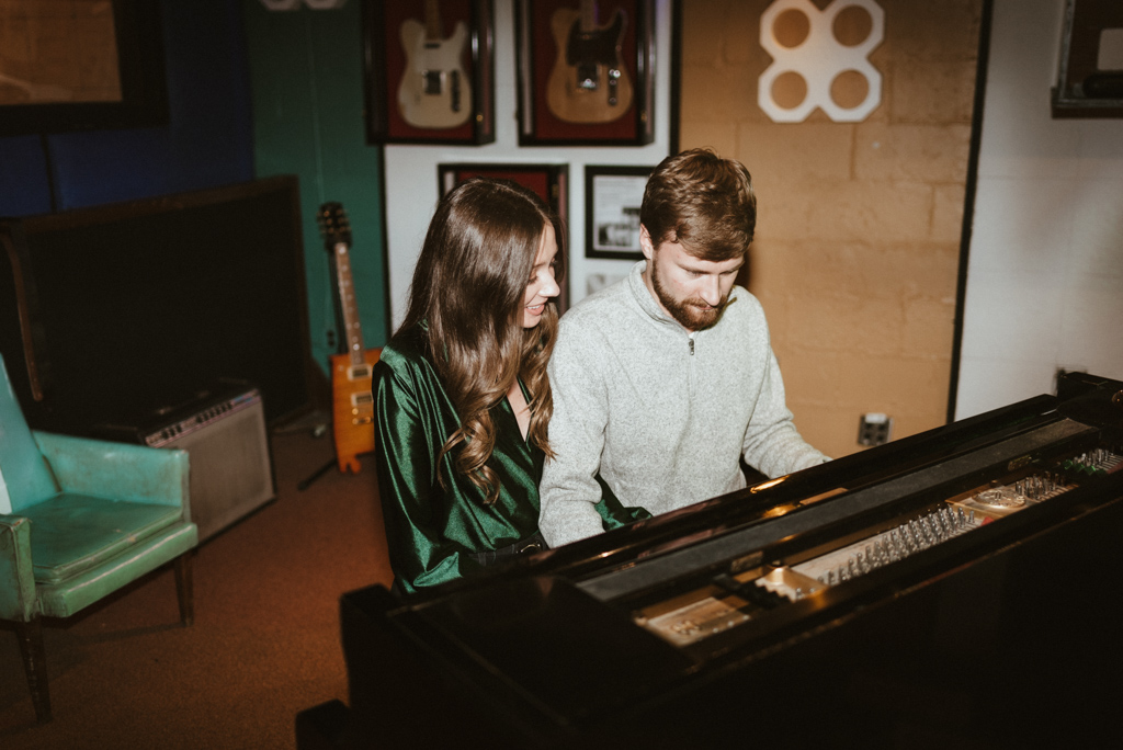 Couple sitting at piano playing