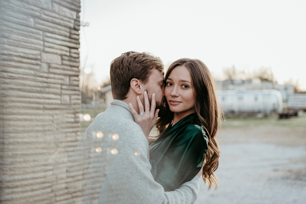 Couple embracing outside of brick building