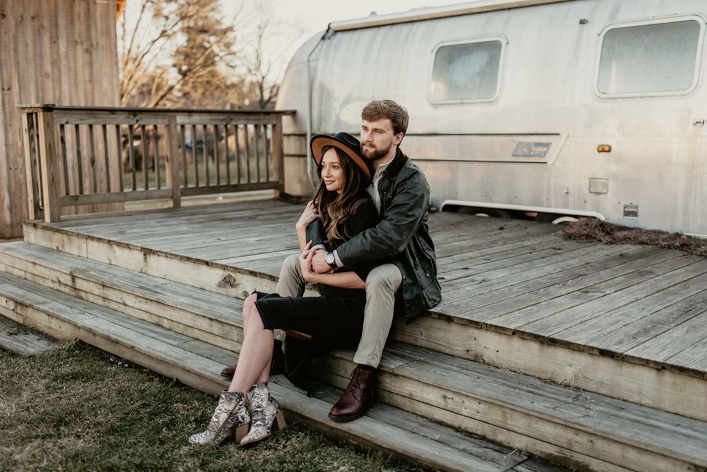 Couple sitting outside of airstream