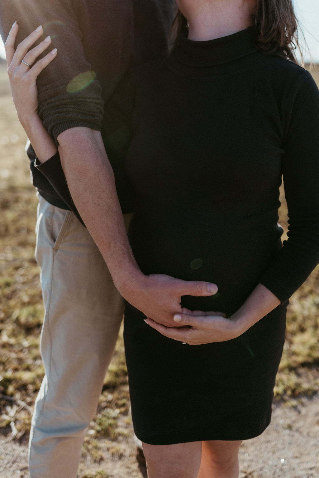 Man holding pregnant woman's belly