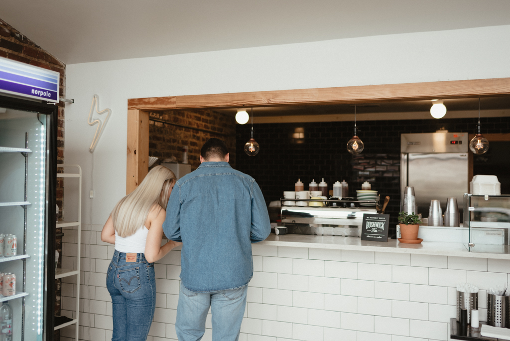 Couple standing at coffee shop counter