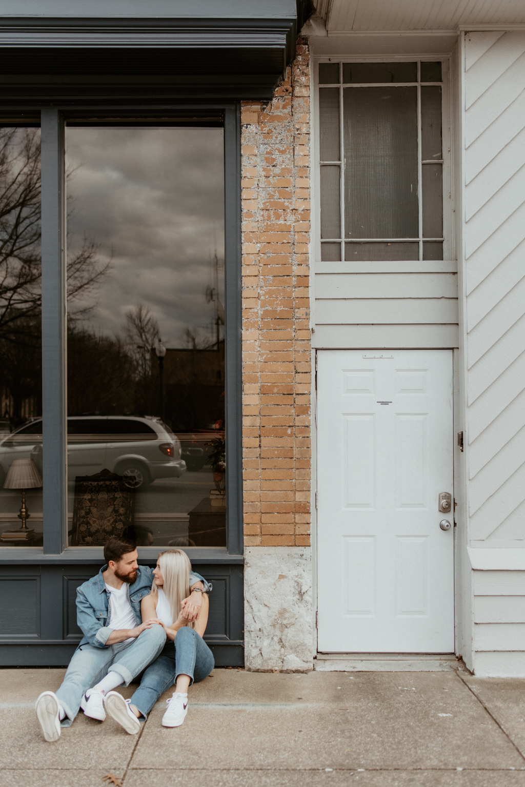 Couple sitting against old downtown building