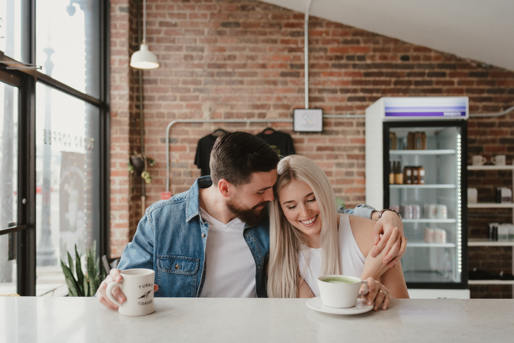 Couple sitting at bar top counter with coffees