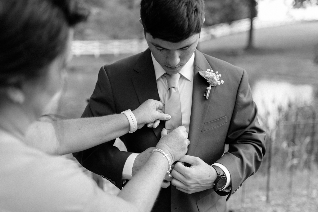 Groom's mother helping with tie