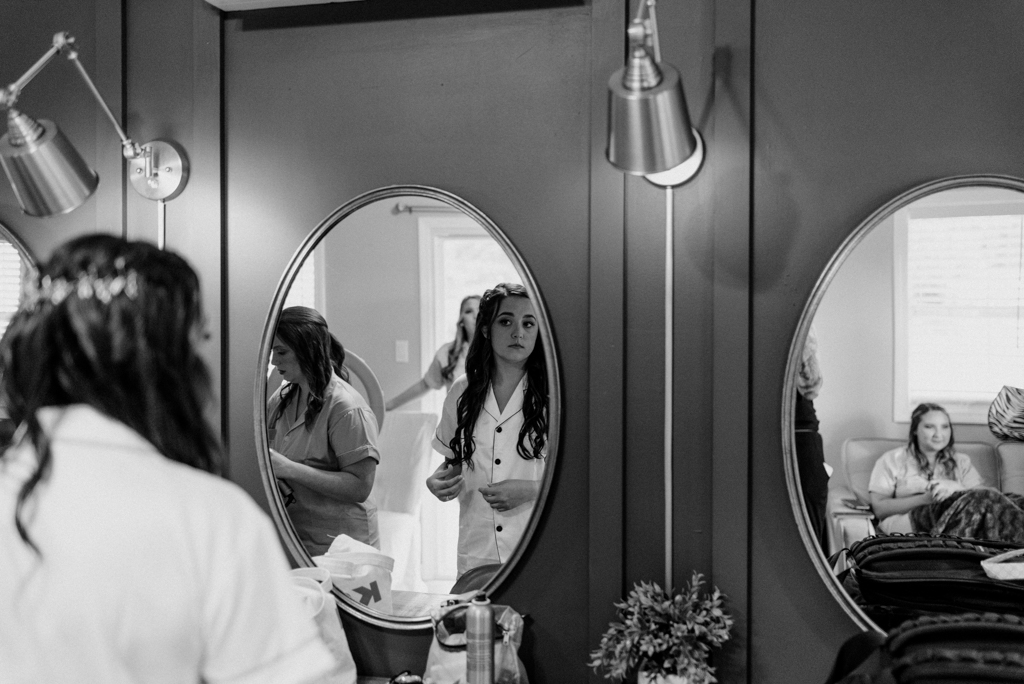 Bride admiring self in mirror